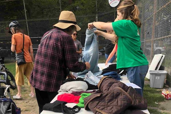 People busy around a table with clothes on.